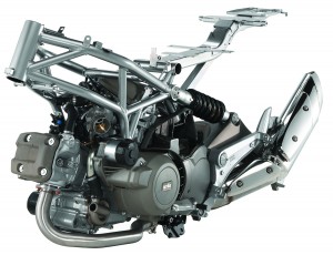 p03146_0201 The Mana’s 90-degree V-twin engine is a stressed member of the steel trellis frame. Rear shock is side-mounted with no linkage. CVT can be shifted with foot lever or buttons in sequential Sportgear mode.