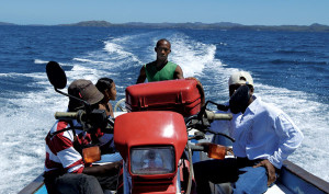 Fun in the Sun in a Boat Surfing the seas at 30 mph. The bike was tied down in the middle of the boat. Unfortunately, every time we came down hard my voice went up three octaves, so I started to move back. “Non!” I was told to return to my position as ballast.“We have 115 horsepower. Very fast, very fun.” He was right.
