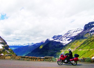 In the background,  Going-to-the-Sun Road clings  precariously to the western flanks of Logan Pass.
