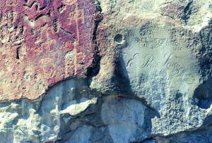 Indian Lands_2 Petroglyphs scratched on El Morro by ancient Puebloans, circa 1300, survive alongside the 1857 signature of pioneer E. Pen Long.