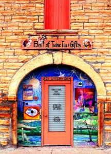 Kansas_33 Storefronts in Cawker City tease the visitor into strolling the sidewalks looking for hidden balls of twine in famous paintings.