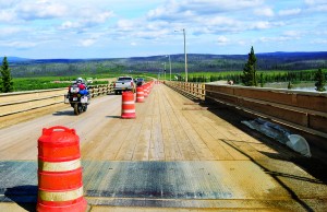 The wooden plank bridge crossing the Yukon is typical of the surface of many bridges on the Dalton and very slippery when wet.