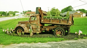 web-rustedtruck What can one do with an old dump truck? An enterprising person can turn it into the centerpiece of a flower garden.