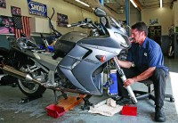 Tony Marasco, Race Tech’s ace suspension tech, at work. One final suspension adjustment before rolling out the door would include setting the bike’s static sag front and rear.