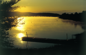 web-Dakotas_27 Sunrise on a misty morning paints a tranquil scene across the Missouri River at Fort Randall, South Dakota.