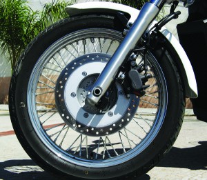 web-IMG_0216 Chromed rims with a few dozen spokes look spiffy but will keep you busy on wash day. The single front disc and twin-piston caliper require a good squeeze for hard stops.