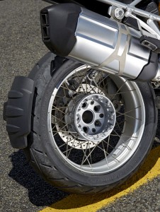 BMW R 1200 GS rear wheel The EVO Paralever single-sided swingarm was moved to the left side of the bike and the exhaust pipe was moved to the right, making the rider less likely to burn himself on the hot exhaust and giving the bike a more attractive look when parked on the sidestand.