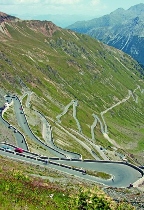 The well-known road up to the Queen of the Alps, 9,045-foot Stelvio Pass in Italy, the second highest paved pass in the range. Note the traffic jam where an RV and several cars are trying to negotiate the same switchback.