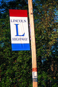 In the days before numbered roads, markings on telephone poles guided travelers. Today, banners remind tourists of the old road.