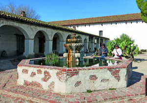 The San Miguel church is in the background, and up front a fountain offering water for man and beast.
