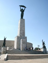 This statue in Budapest has been named The Statue of Liberty, an heroic woman standing on a column with her arms upraised and holding what appears to be a palm leaf. It was erected by the Russians in 1947 to celebrate their victory in the war.