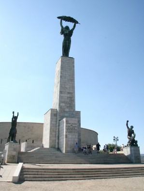 This statue in Budapest has been named The Statue of Liberty, an heroic woman standing on a column with her arms upraised and holding what appears to be a palm leaf. It was erected by the Russians in 1947 to celebrate their victory in the war.