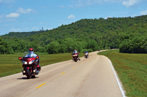 Riding through this lush, green corridor, you lose your sense of time and place. Progress is measured by simple, brown roadside mile-markers.