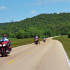 Riding through this lush, green corridor, you lose your sense of time and place. Progress is measured by simple, brown roadside mile-markers.